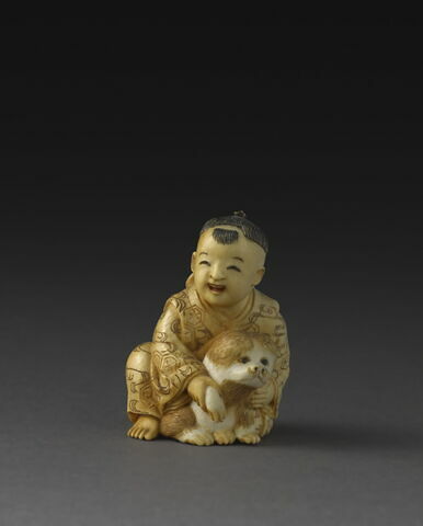 Netsuke : Enfant avec un chien